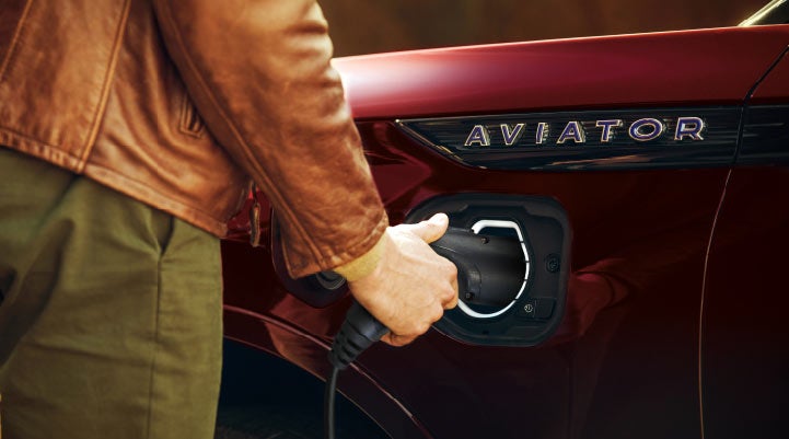 A hand is shown plugging in the charger into the charging port of a 2021 Lincoln Aviator | Kindle Lincoln in Cape May Court House NJ