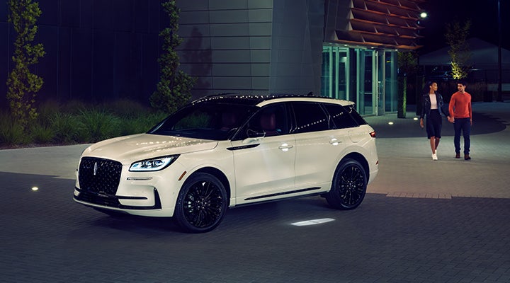 Two people approach a 2024 Lincoln Corsair® SUV featuring the available Jet Appearance Package. | Kindle Lincoln in Cape May Court House NJ