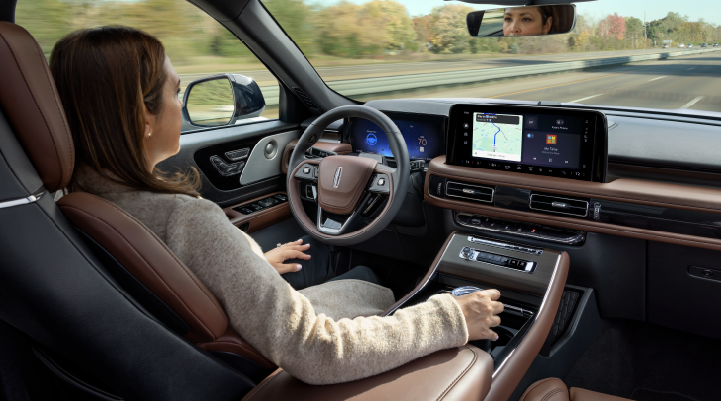 A woman is seen sitting in the driver’s seat of her 2025 Lincoln Aviator® SUV with her hands off the steering wheel. | Kindle Lincoln in Cape May Court House NJ