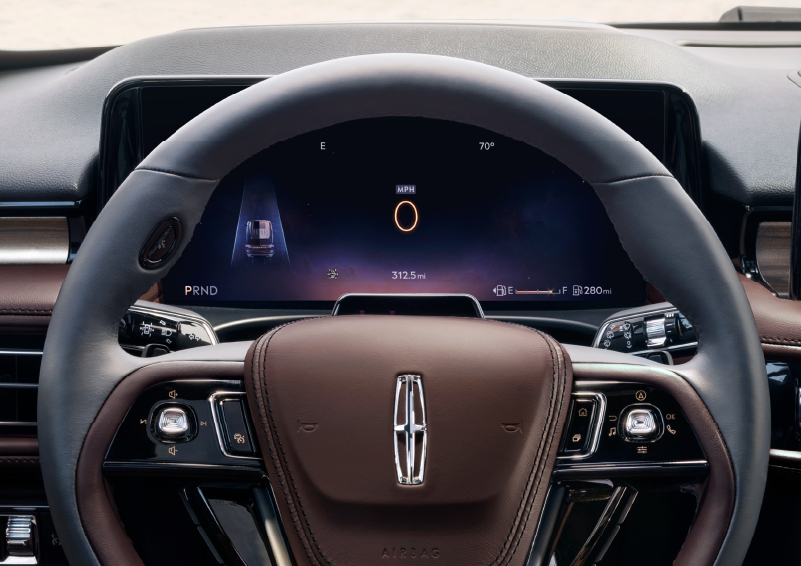 The steering wheel of 2025 Lincoln Aviator® SUV is shown with black and brown accents. | Kindle Lincoln in Cape May Court House NJ