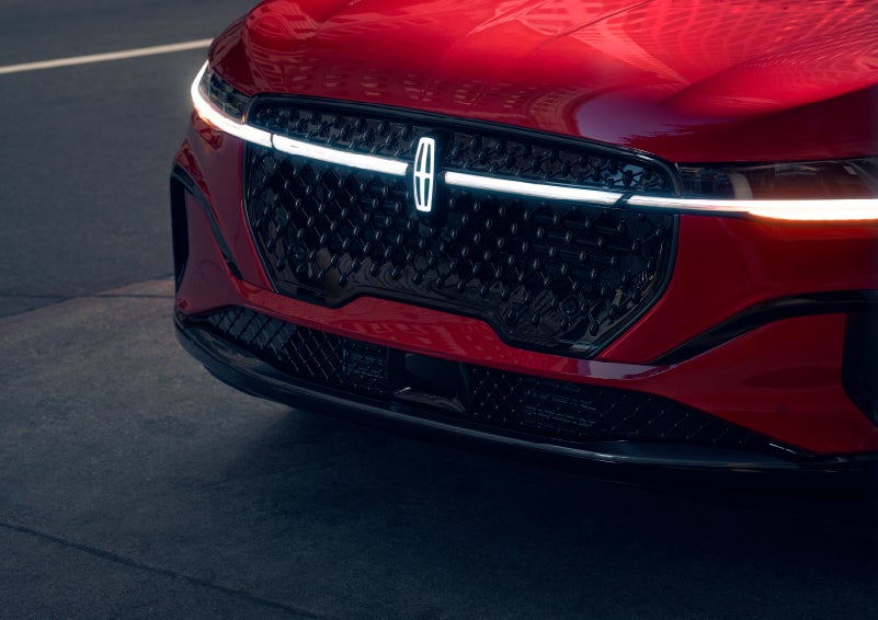 The available front LED light bar and center Lincoln Star logo glow at dusk. | Kindle Lincoln in Cape May Court House NJ