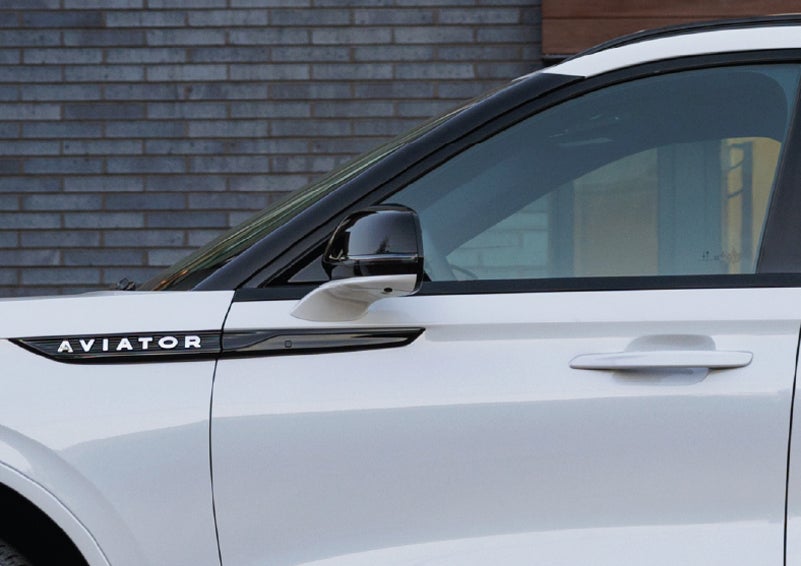 The driver’s side door and fender badging of a white 2026 Lincoln Aviator® SUV are showcased. | Kindle Lincoln in Cape May Court House NJ