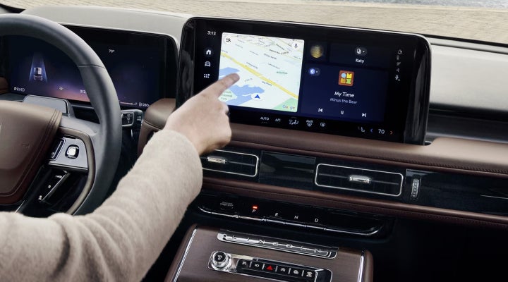 A person is tapping the center display touchscreen of a 2026 Lincoln Aviator® SUV. | Kindle Lincoln in Cape May Court House NJ