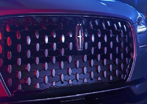 The grille of a 2025 Lincoln Corsair&reg; SUV reflects neon light at night. | Kindle Lincoln in Cape May Court House NJ